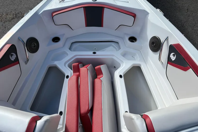 Slide: The Image of Interior of 2023 Scarab 215 ID boat with red and white seating and speakers. - 19