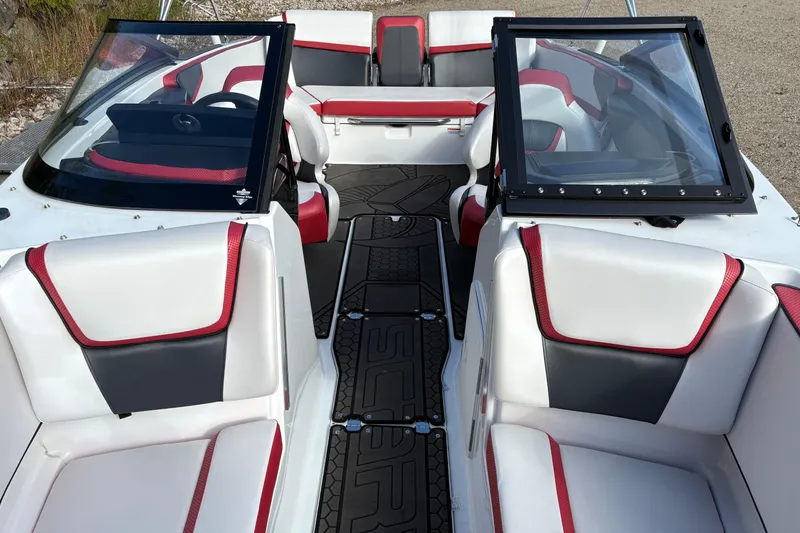 Slide: The Image of 2023 Scarab 215 ID boat interior with red and white seating, black accents. - 20