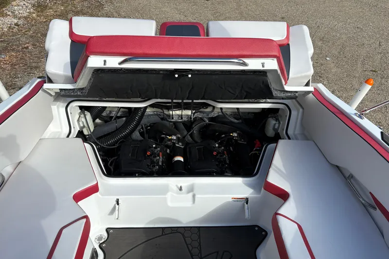 Slide: The Image of 2023 Scarab 215 ID boat engine compartment with red and white seating. - 22