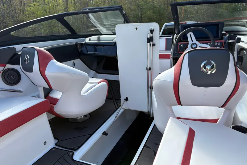 Slide: The Image of 2023 Scarab 215 ID boat interior with red and white seating, modern dashboard, and open cockpit. - 24