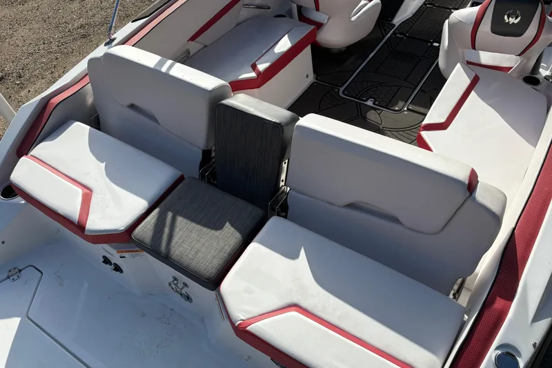 Slide: The Image of 2023 Scarab 215 ID boat interior with white and red seating arrangement. - 25