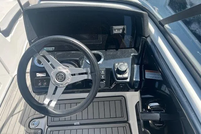 Slide: The Image of 2022 Yamaha 242SE boat dashboard with steering wheel and controls. - 5