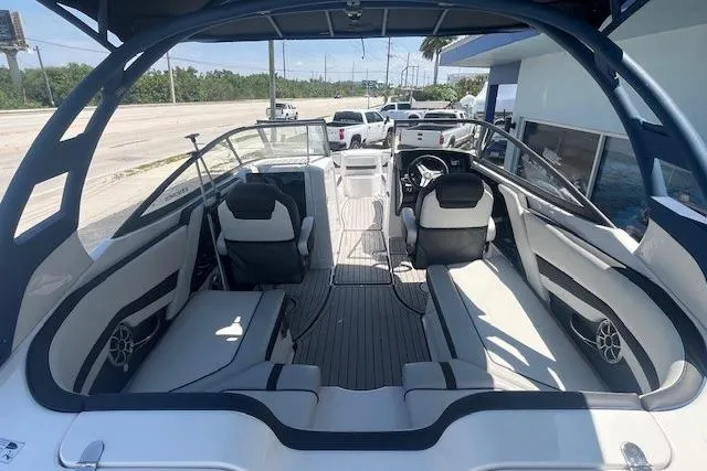 Slide: The Image of 2022 Yamaha 242SE boat interior with sleek seating and modern dashboard design. - 9