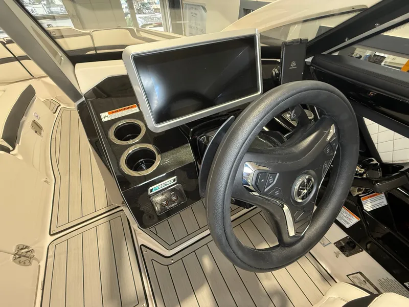 Slide: The Image of The image shows the cockpit of a 2026 Yamaha Boats 275SD with a modern steering wheel and large screen. - 14
