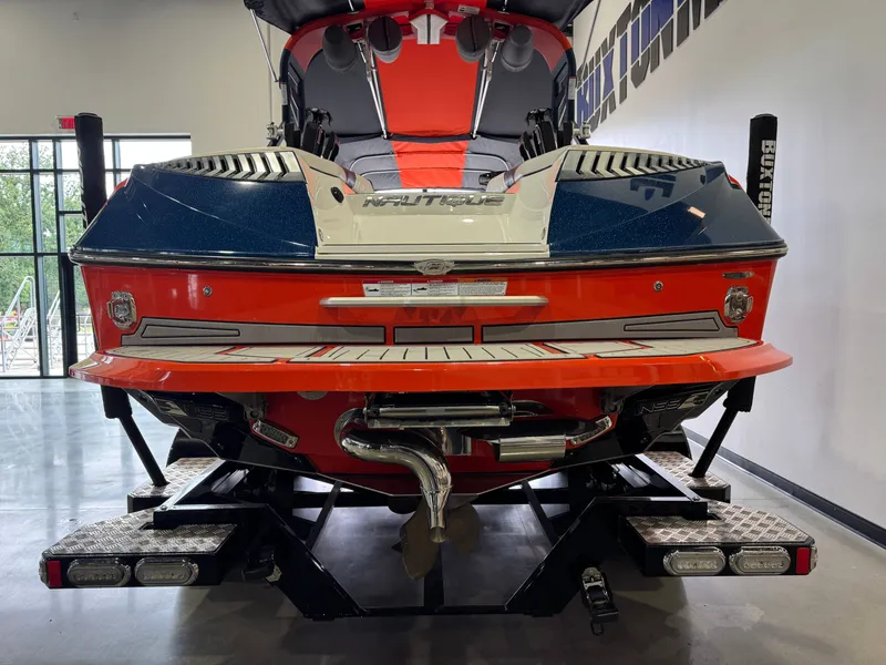 Slide: The Image of Rear view of a 2019 Nautique Super Air Nautique G25 boat in showroom. - 7