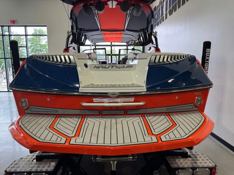 Slide: The Image of Rear view of a 2019 Nautique Super Air Nautique G25 boat in showroom. - 9