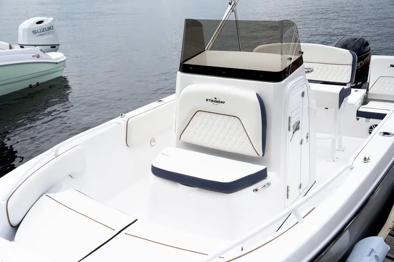 Slide: The Image of 2026 Stingray 173 CC boat on calm water, modern design. - 9