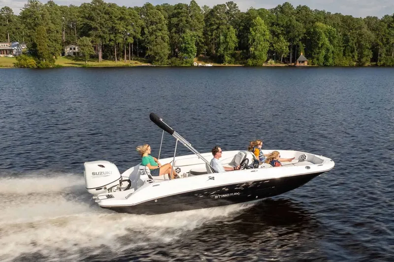 Slide: The Image of Stingray 182 SC 2026 boat on a lake with passengers. - 12