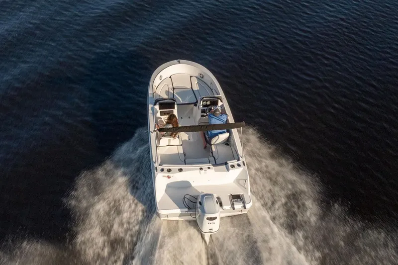 Slide: The Image of Stingray 172 DC 2026 boat cruising on calm water, aerial view. - 12