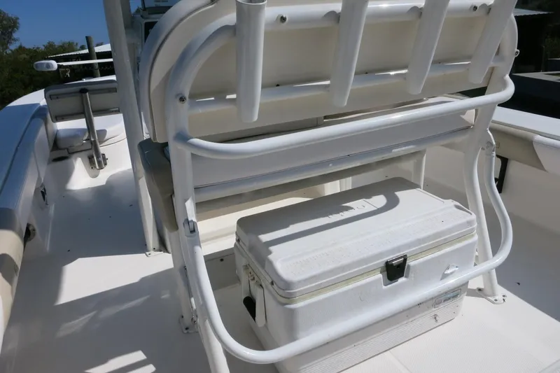 Slide: The Image of 2018 Robalo 246 Cayman boat interior with seating and storage cooler. - 10