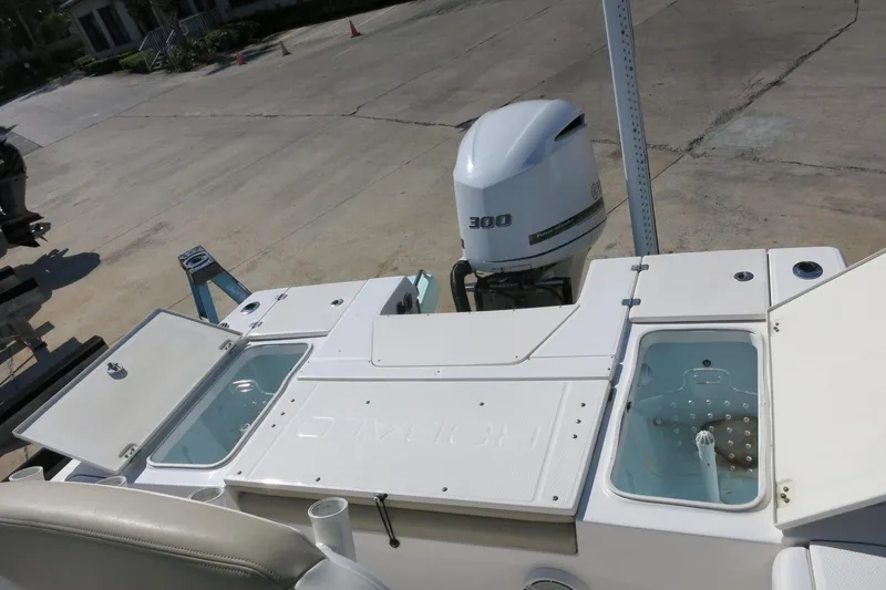 Slide: The Image of 2018 Robalo 246 Cayman boat with Yamaha 300 engine, featuring open storage compartments. - 11