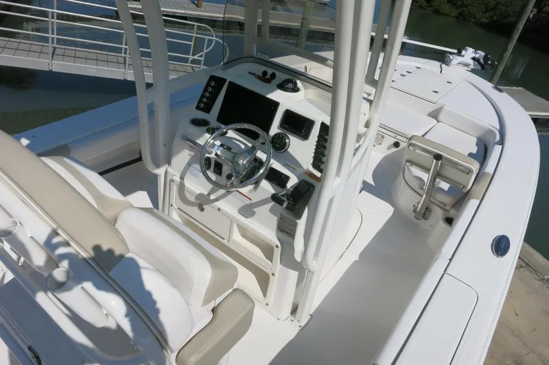 Slide: The Image of 2018 Robalo 246 Cayman boat interior with steering console and seating. - 14