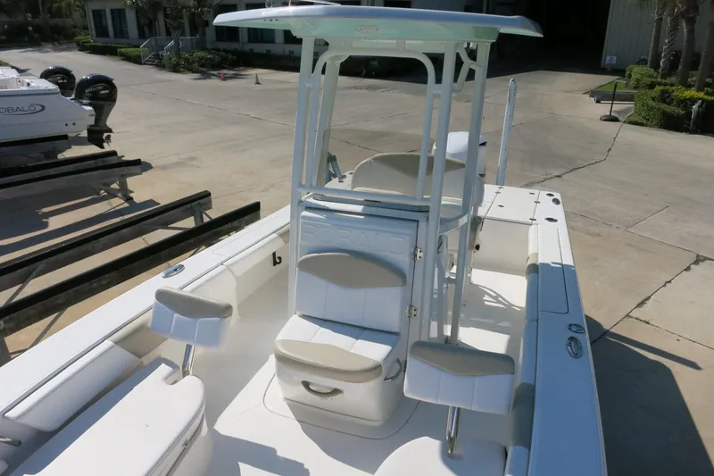Slide: The Image of 2018 Robalo 246 Cayman boat with seating and console, docked outdoors. - 20