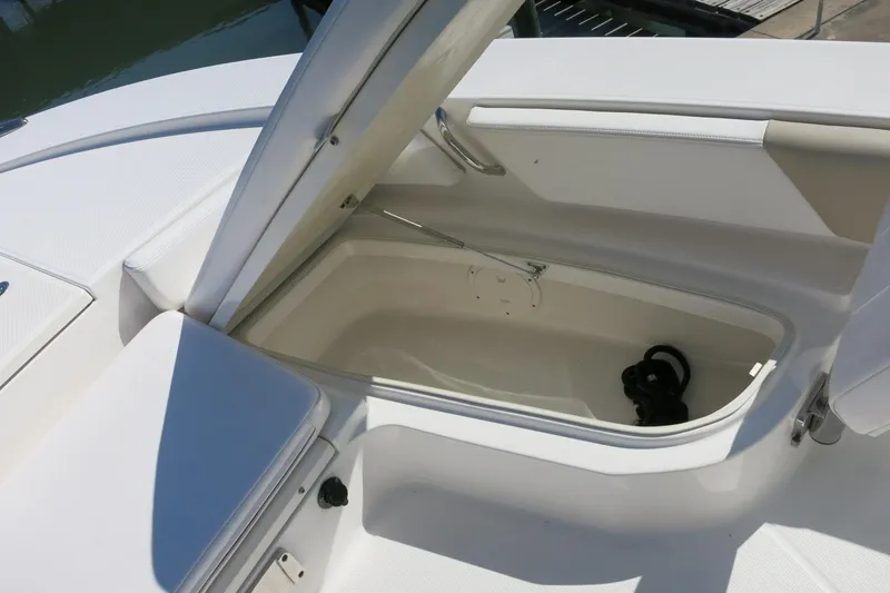 Slide: The Image of Open storage compartment on a 2018 Robalo 246 Cayman boat, showcasing interior space. - 22