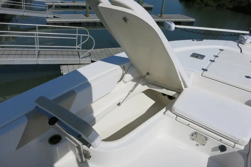 Slide: The Image of 2018 Robalo 246 Cayman boat with open storage compartment at marina dock. - 23
