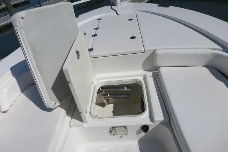 Slide: The Image of 2018 Robalo 246 Cayman boat storage compartment open, showcasing interior space. - 24