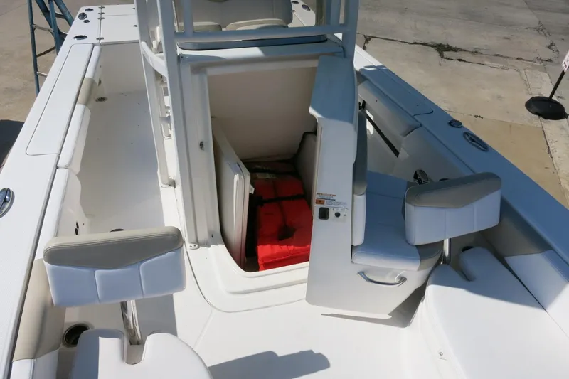 Slide: The Image of 2018 Robalo 246 Cayman boat interior with storage compartment and seating. - 26