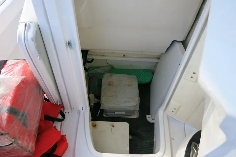 Slide: The Image of Storage compartment of a 2018 Robalo 246 Cayman boat with life jackets and equipment. - 27