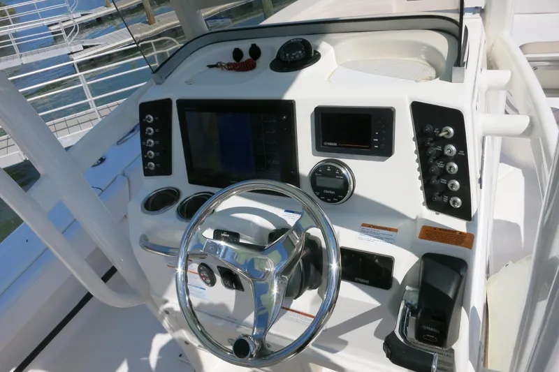 Slide: The Image of Control panel of a 2018 Robalo 246 Cayman boat with steering wheel and navigation instruments. - 30