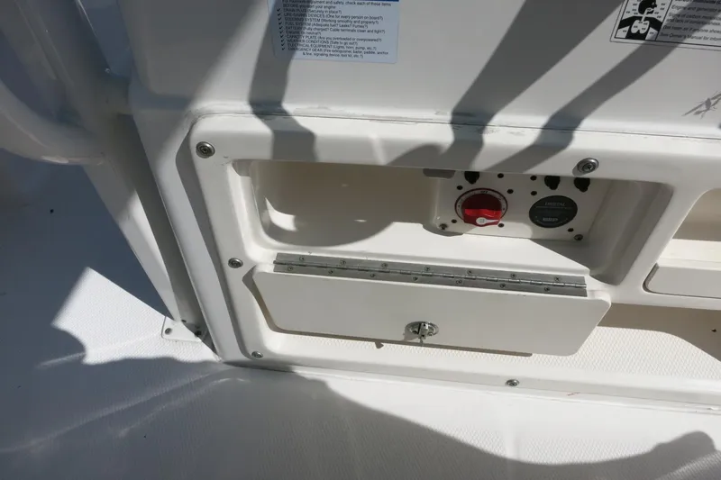 Slide: The Image of Control panel on a 2018 Robalo 246 Cayman boat, featuring switches and storage compartment. - 31