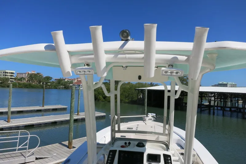 Slide: The Image of 2018 Robalo 246 Cayman boat docked by a scenic waterfront. - 33