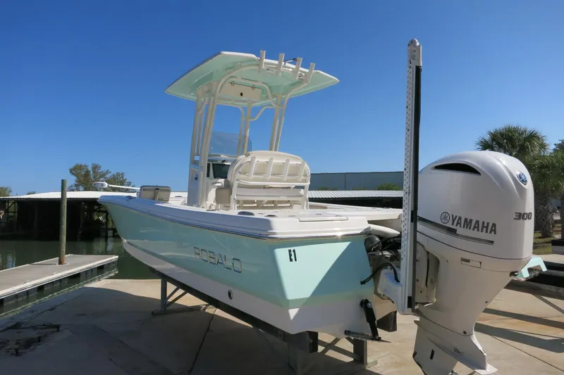 Slide: The Image of 2018 Robalo 246 Cayman boat with Yamaha 300 engine, docked under clear blue sky. - 5