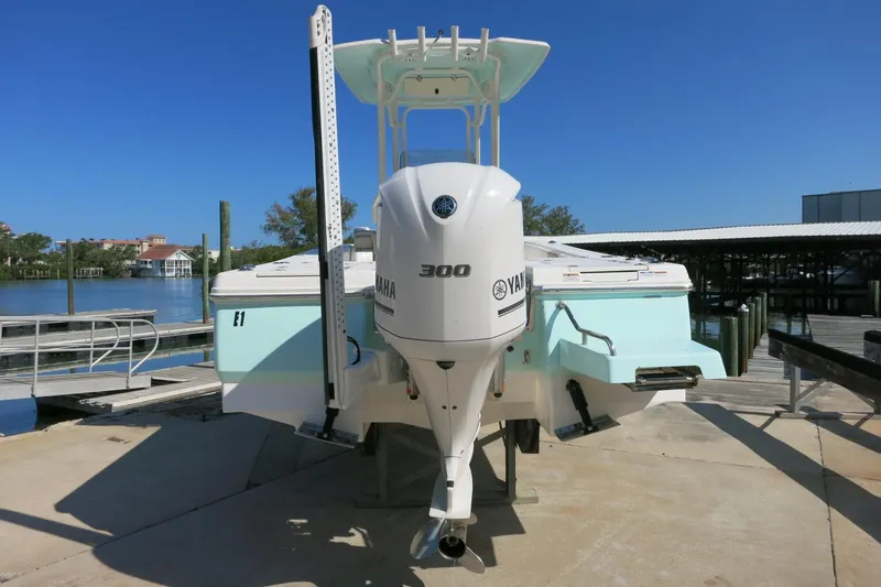 Slide: The Image of 2018 Robalo 246 Cayman boat with Yamaha 300 engine, docked by the waterfront. - 6