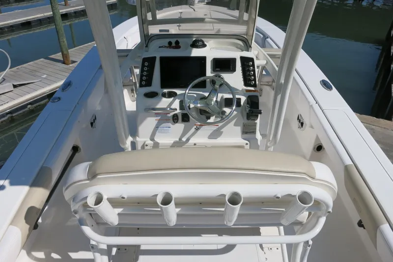 Slide: The Image of 2018 Robalo 246 Cayman boat cockpit with steering wheel and control panel. - 8