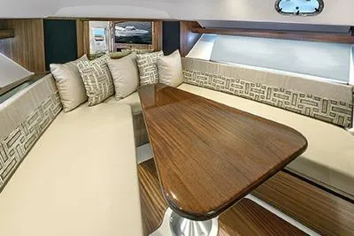 Slide: The Image of Luxurious interior of 2026 Pursuit OS 355 Offshore yacht with elegant seating and wooden table. - 12