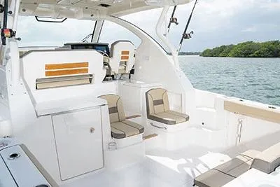 Slide: The Image of 2026 Pursuit OS 355 Offshore boat interior with seating, white finish, and scenic water view. - 6