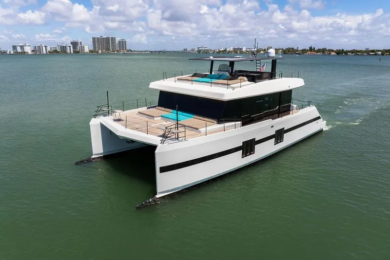 The Image of Luxurious 2018 Sunreef 68 Supreme yacht cruising on calm waters under a partly cloudy sky. - 0