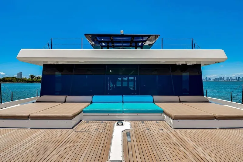 Slide: The Image of Luxurious Sunreef 68 Supreme 2018 yacht with spacious deck and sunbeds, overlooking serene waters. - 11