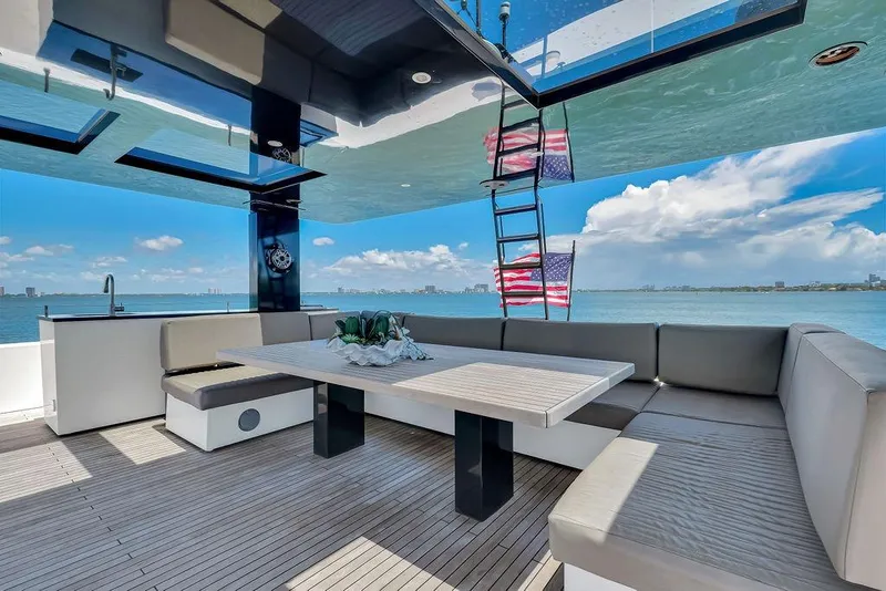 Slide: The Image of Luxurious Sunreef 68 Supreme yacht deck with seating, table, and ocean view, 2018 model. - 16