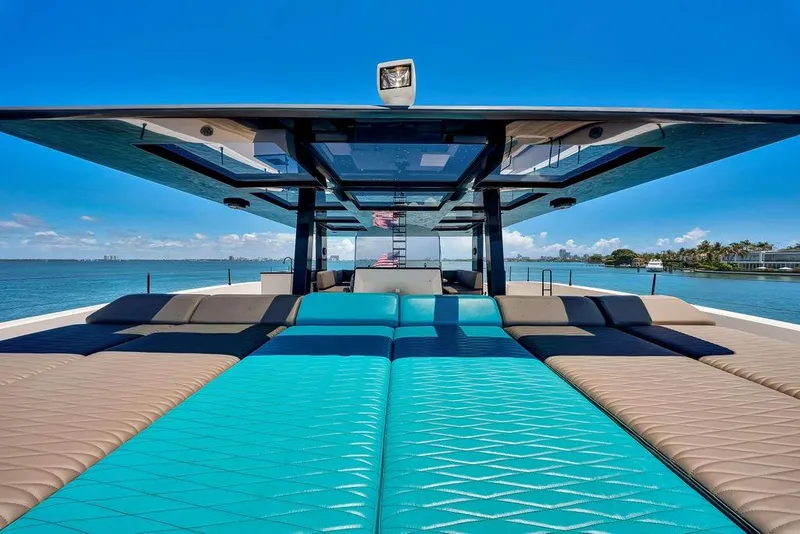 Slide: The Image of Luxurious Sunreef 68 Supreme yacht deck with turquoise seating, 2018 model, under clear blue sky. - 18