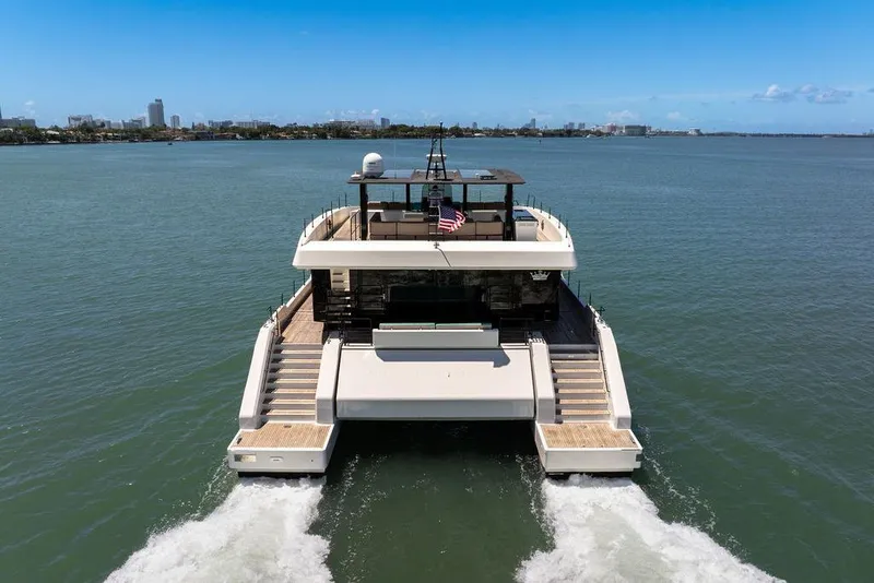Slide: The Image of 2018 Sunreef 68 Supreme yacht cruising on open water, rear view. - 4