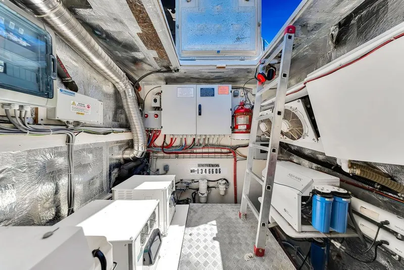 Slide: The Image of Engine room of a 2018 Sunreef 68 Supreme yacht, featuring equipment and a ladder. - 40