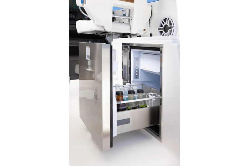 Slide: The Image of Stainless steel refrigerator on 2026 Pursuit OS 325 Offshore boat, stocked with beverages. - 13