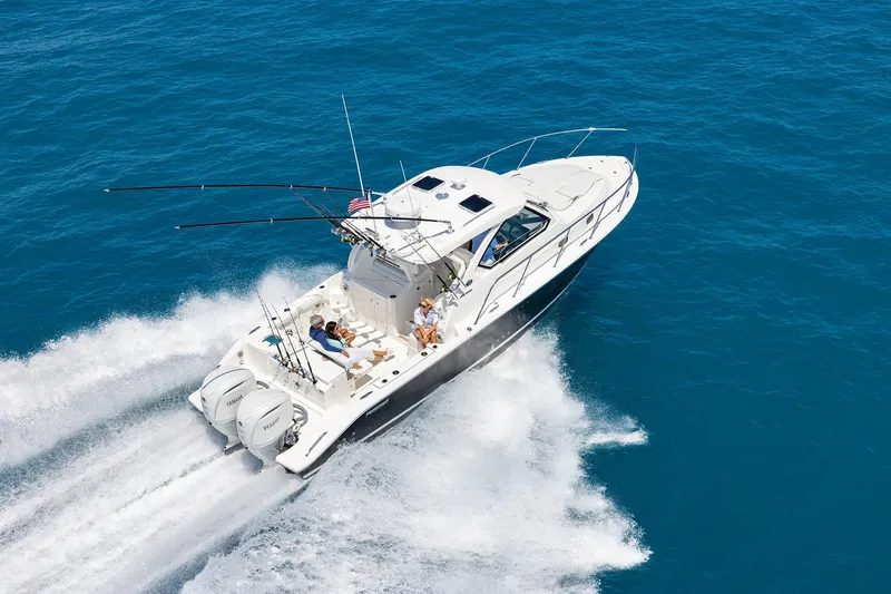Slide: The Image of 2026 Pursuit OS 325 Offshore cruising on open blue water, showcasing speed and luxury. - 2