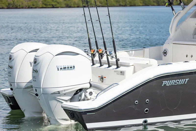 Slide: The Image of 2026 Pursuit OS 325 Offshore boat with dual Yamaha engines on calm water. - 5
