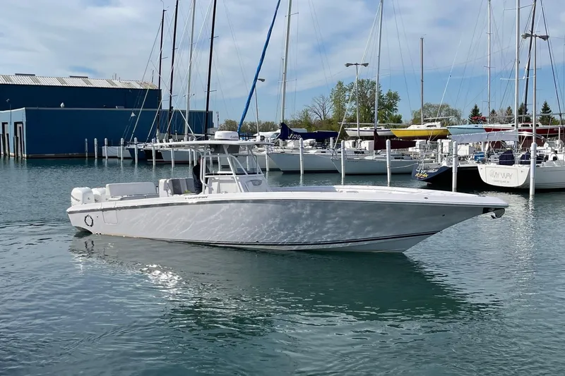 The Image of 2018 Fountain 38 Center Console boat docked in a marina with sailboats. - 0
