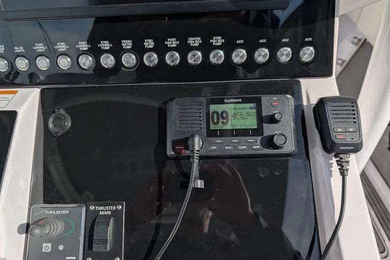 Slide: The Image of Control panel of a 2018 Fountain 38 Center Console boat with Garmin radio and switches. - 13