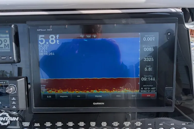 Slide: The Image of Garmin GPS display on 2018 Fountain 38 Center Console, showing depth and navigation data. - 14