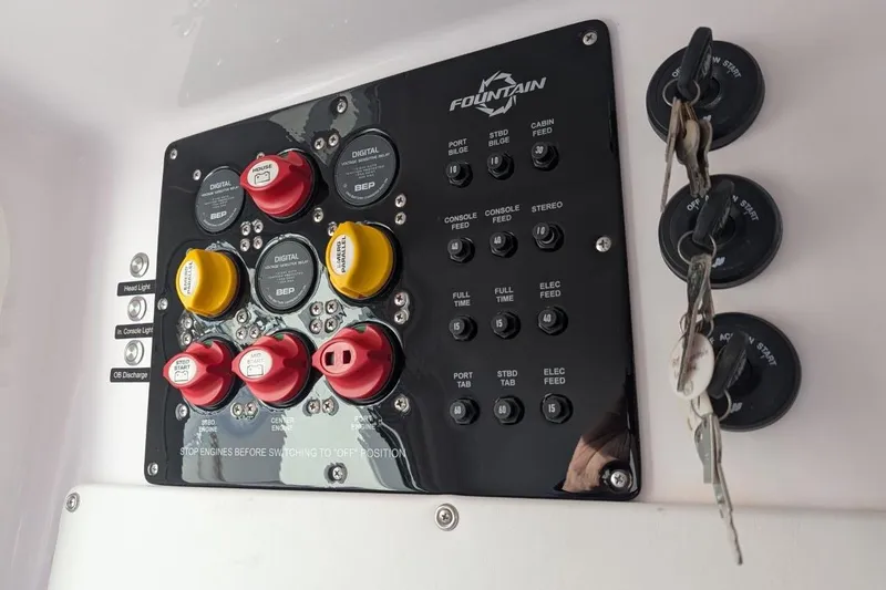 Slide: The Image of Control panel of a 2018 Fountain 38 Center Console boat with switches and keys. - 16