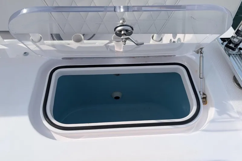 Slide: The Image of Open storage compartment on 2018 Fountain 38 Center Console boat. - 17