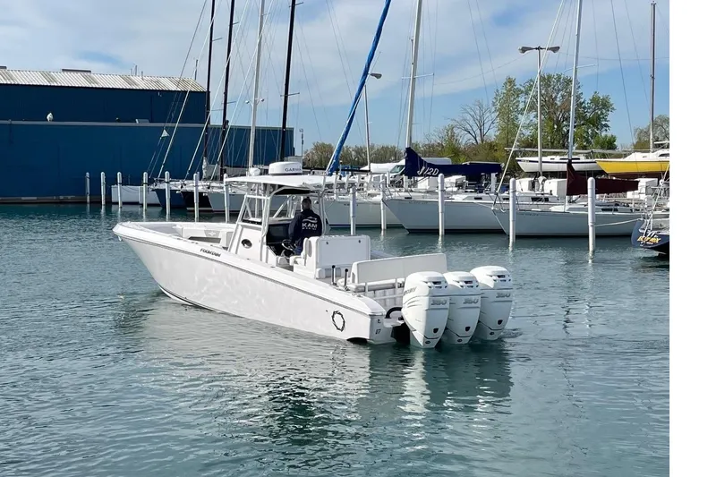 Slide: The Image of 2018 Fountain 38 Center Console boat docked in marina with multiple outboard engines. - 4