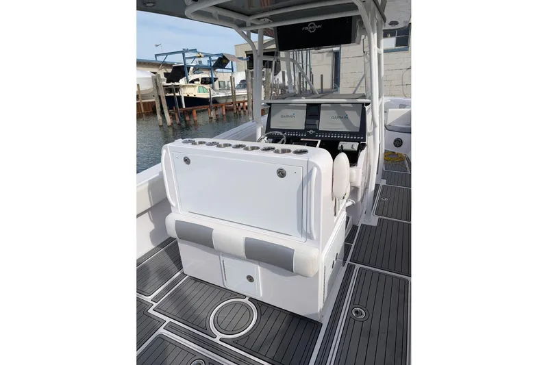 Slide: The Image of 2018 Fountain 38 Center Console boat interior with Garmin displays and sleek seating. - 7