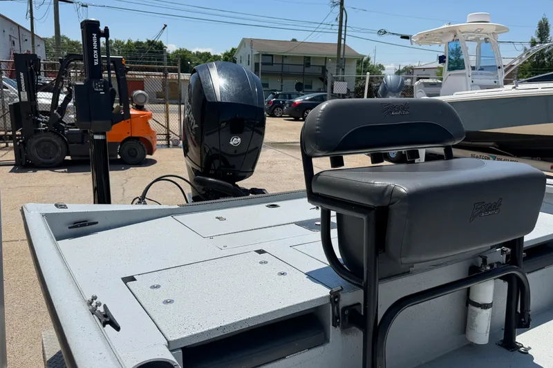 Slide: The Image of 2018 Excel 203 Bay Pro boat with seating and motor in a marina setting. - 10