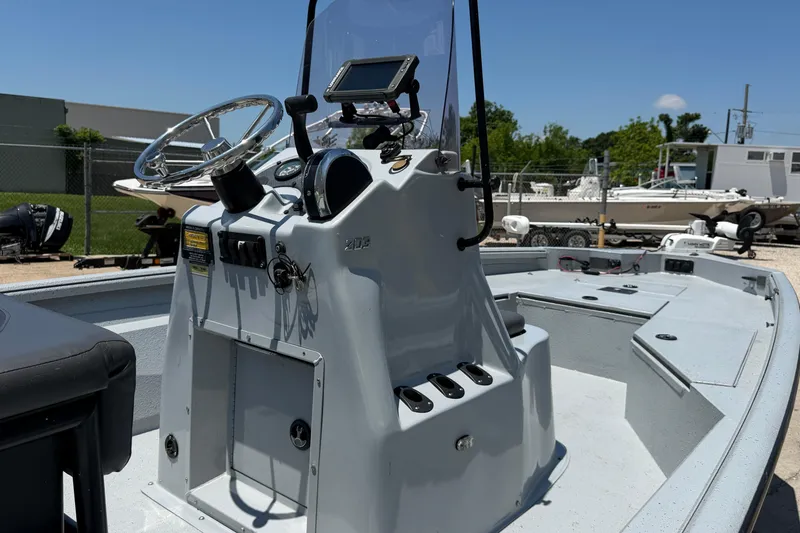 Slide: The Image of 2018 Excel 203 Bay Pro boat console with steering wheel and navigation equipment. - 11