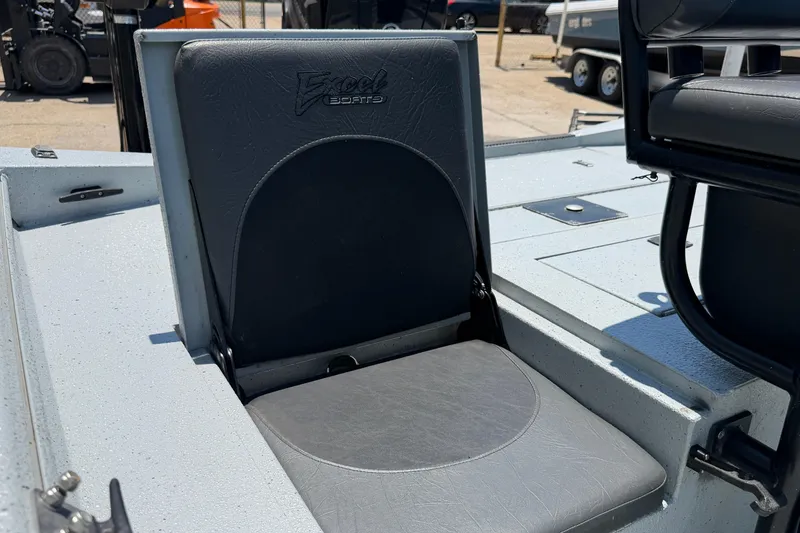 Slide: The Image of 2018 Excel 203 Bay Pro boat seat, gray upholstery, outdoor setting. - 12