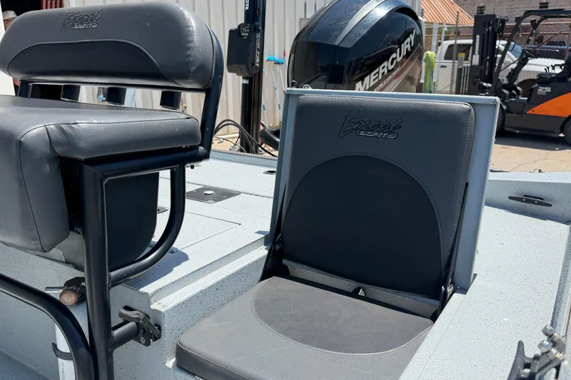 Slide: The Image of 2018 Excel 203 Bay Pro boat seats with Mercury engine in background. - 13